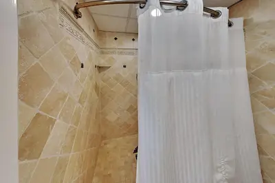 a white shower curtain in a bathroom at Edgewater Tower II 2 in Panama City Beach