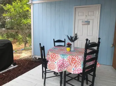 a table with a table cloth on a patio at Beachy Bungalow, Santa Rosa Beach, FL near Gulf in Santa Rosa Beach