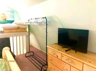 a living room with a tv and a dresser with a televisionicter at Beachy Bungalow, Santa Rosa Beach, FL near Gulf in Santa Rosa Beach
