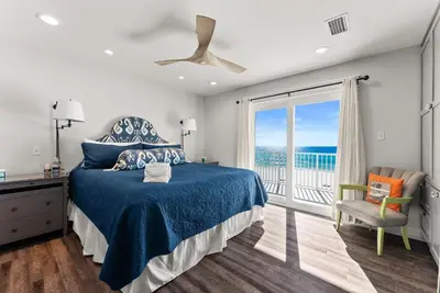 a bedroom with a bed and a large window at Dreamscape 30! Luxury Beach Front Property! in Panama City Beach