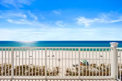 a white fence with the ocean in the background at Dreamscape 30! Luxury Beach Front Property! in Panama City Beach