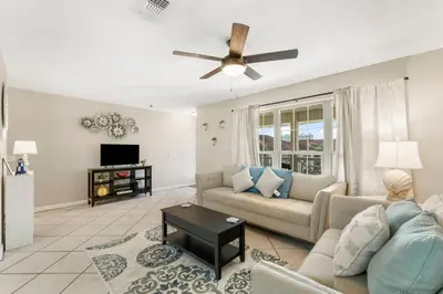 a living room with a couch and a ceiling fan at Horizon South 56 - 206 in Panama City Beach