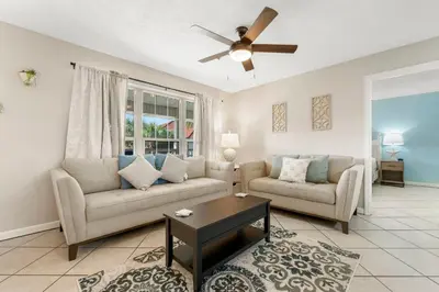 a living room with two couches and a ceiling fan at Horizon South 56 - 206 in Panama City Beach