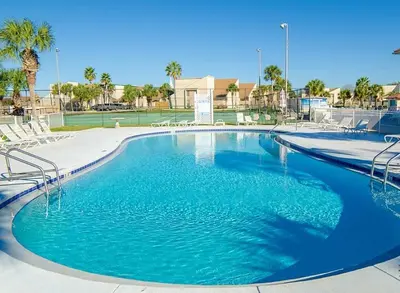 a swimming pool with blue water in a resort at Horizon South 56 - 206 in Panama City Beach