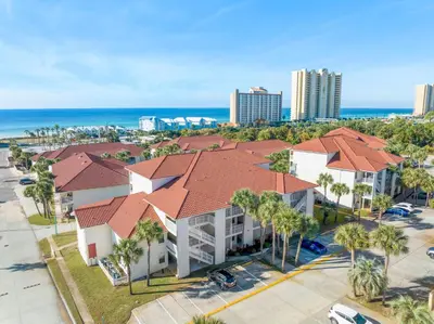 an aerial view of a building with palm trees and the ocean at Horizon South 56 - 206 in Panama City Beach