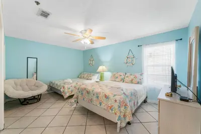 a bedroom with two beds and a ceiling fan at Horizon South 56 - 206 in Panama City Beach