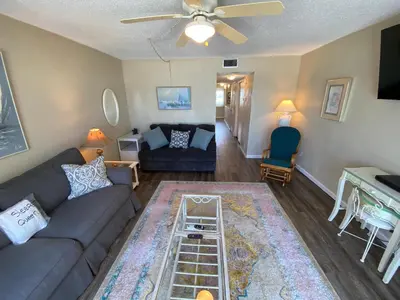 a living room with a couch and a ceiling fan at Beautiful Beach Front Condo at Pinnacle Port A-125 in Panama City Beach