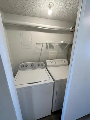 a small kitchen with a stove and a washer at Beautiful Beach Front Condo at Pinnacle Port A-125 in Panama City Beach