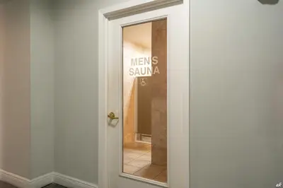 a glass door with a sign that says mens swimalia at Beautiful Beach Front Condo at Pinnacle Port A-125 in Panama City Beach