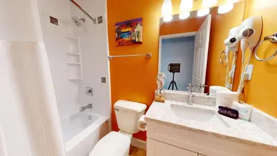 a bathroom with a sink and a toilet and a tub at Tidewater 1003 in Panama City Beach