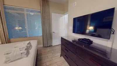 a living room with a large flat screen tv at Tidewater 1003 in Panama City Beach