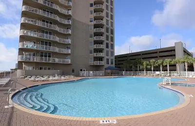 a large swimming pool in front of a building at Tidewater 1003 in Panama City Beach