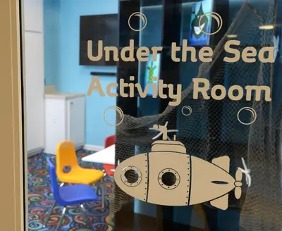 a room with a door with a toy ship on it at Tidewater 1003 in Panama City Beach