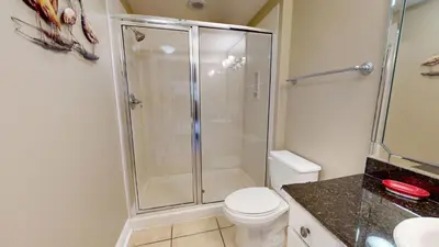a bathroom with a shower and a toilet at Calypso I 407E in Panama City Beach