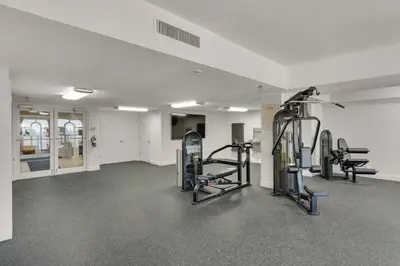a gym with treadmills and ellipticals in a room at Calypso I 407E in Panama City Beach