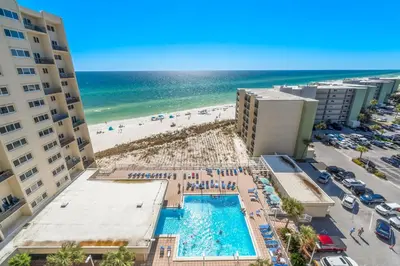 an aerial view of a pool and the beach at Fabulous 3-Bed 3-Bath Condo with Private Covered Parking Space! in Panama City Beach