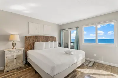 a bedroom with a bed with a view of the ocean at Beautiful Gulf and Lake views from Pinnacle Port A-935! in Panama City Beach