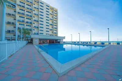 a large swimming pool in front of a building at Beautiful Gulf and Lake views from Pinnacle Port A-935! in Panama City Beach