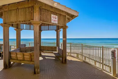 a wooden gazebo on a beach with the ocean at Treasure Island #2112 in Panama City Beach