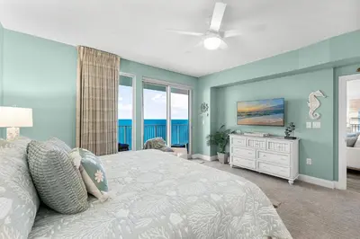 a bedroom with a bed with a view of the ocean at Treasure Island #2112 in Panama City Beach