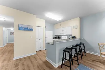 a kitchen with a counter and stools in a room at Shores Of Panama #1224 in Panama City Beach