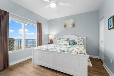 a bedroom with a bed and a large window at Shores Of Panama #1224 in Panama City Beach