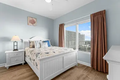a bedroom with a bed and a window at Shores Of Panama #1224 in Panama City Beach
