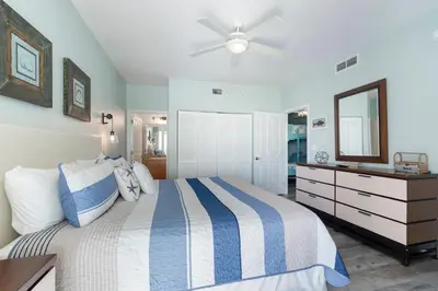 a bedroom with a bed and a ceiling fan at Aqua 511 in Panama City Beach