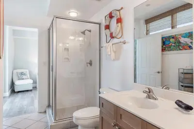 a bathroom with a shower and a toilet and a sink at Aqua 511 in Panama City Beach