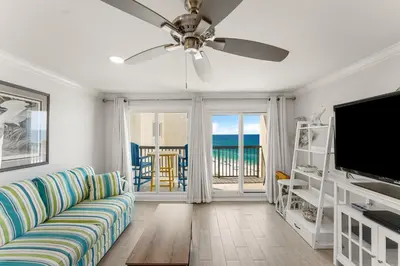 a living room with a couch and a flat screen tv at Beautiful Beach Front Paradise at Pinnacle Port B2-608! in Panama City Beach
