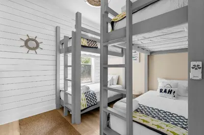 a bedroom with two bunk beds and a window at Coastal Vue in Seacrest