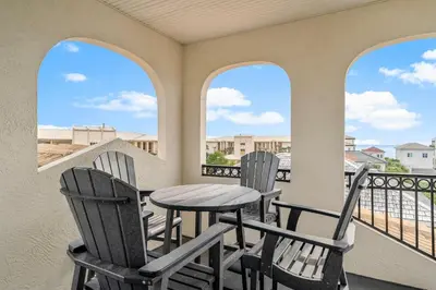 a balcony with a table and chairs on a balcony at Coastal Vue in Seacrest
