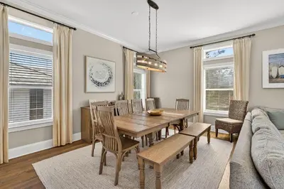 a dining room with a table and chairs and a couch at Coastal Vue in Seacrest