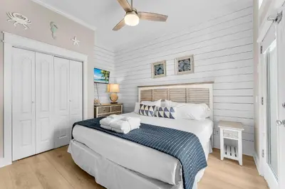 a bedroom with a bed and a ceiling fan at Coastal Vue in Seacrest