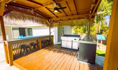 a wooden deck with a bar and a grill at Panhandle Paradise, Heated Pool, Hot Tub, Mini & Disc Golf, Game Room in Panama City Beach