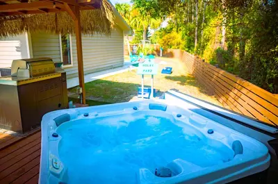 a hot tub on a deck with a backyard at Panhandle Paradise, Heated Pool, Hot Tub, Mini & Disc Golf, Game Room in Panama City Beach