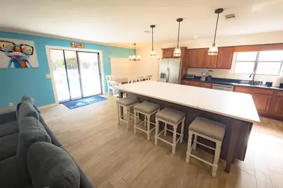 a kitchen with a large table and chairs in it at Panhandle Paradise, Heated Pool, Hot Tub, Mini & Disc Golf, Game Room in Panama City Beach