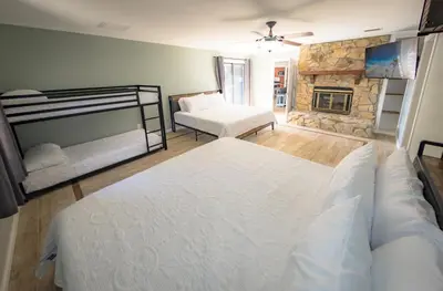 a bedroom with two bunk beds and a fireplace at Panhandle Paradise, Heated Pool, Hot Tub, Mini & Disc Golf, Game Room in Panama City Beach