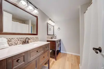 a bathroom with a sink and a mirror at Sandy Bottoms PPC3 - 401! Gulf Front Views! in Panama City Beach