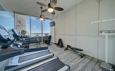 a room with a hair salon with chairs and a treadmill at Sandy Bottoms PPC3 - 401! Gulf Front Views! in Panama City Beach
