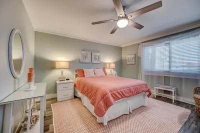 a bedroom with a bed and a ceiling fan at Our Happy Place! Seasonal Beach SRV! Pool & Gulf Views! in Panama City Beach