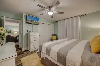 a bedroom with a bed and a ceiling fan at Our Happy Place! Seasonal Beach SRV! Pool & Gulf Views! in Panama City Beach