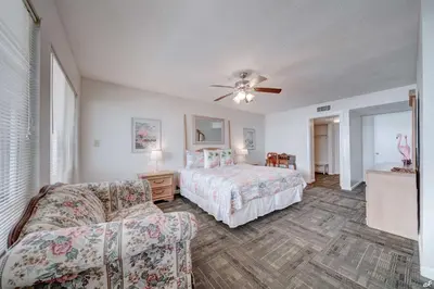 a bedroom with a bed and a couch at Toes in the Sand at Shores #101 in Panama City Beach