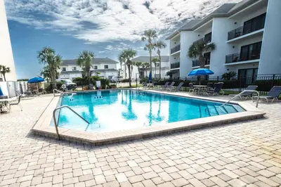 a swimming pool in front of a building at Emerald Hill Unit #15 Gulf Front ground floor in Santa Rosa Beach