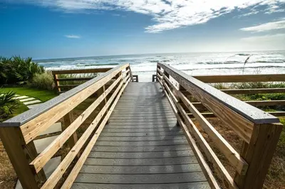 a wooden boardwalk leading to the beach at Emerald Hill Unit #15 Gulf Front ground floor in Santa Rosa Beach
