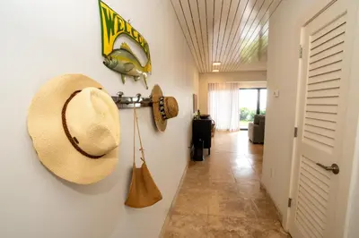 a hallway with a straw hat hanging on a wall at Emerald Hill Unit #15 Gulf Front ground floor in Santa Rosa Beach