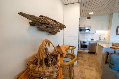 a kitchen with a table and a basket on the wall at Emerald Hill Unit #15 Gulf Front ground floor in Santa Rosa Beach