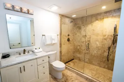 a bathroom with a shower and a toilet and a sink at Emerald Hill Unit #15 Gulf Front ground floor in Santa Rosa Beach