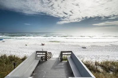a staircase leading to a beach with the ocean at Emerald Hill Unit #15 Gulf Front ground floor in Santa Rosa Beach