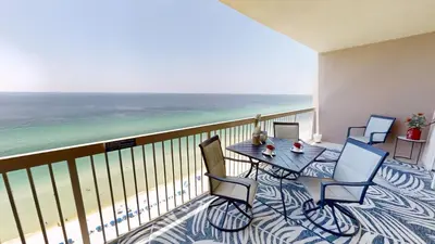 a balcony with a table and chairs and the ocean at Sunrise Beach 2007 in Panama City Beach